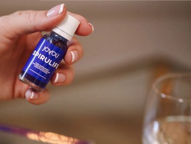 Female hand holding SpiruLife supplement — phycocyanin antioxidant from spirulina extract.
Close-up of woman’s hand presenting SpiruLife superfood capsules with spirulina.