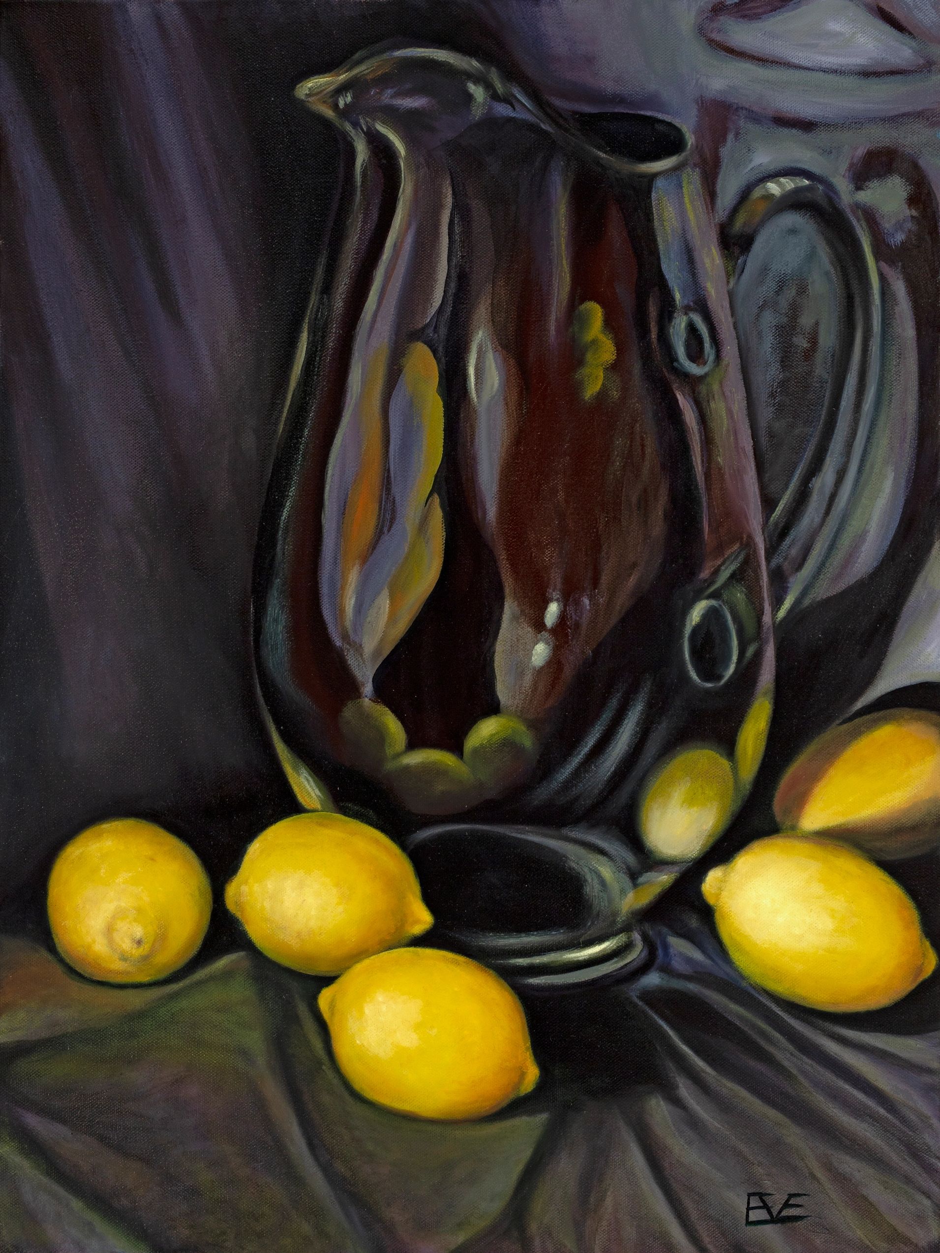 Still life, lemons and a glass pitcher on a black backdrop