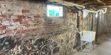 Medford stone foundation in need of repairs.