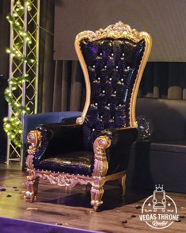 Black & gold high-back throne on stage rented from Vegas Throne Rental luxury events & celebrations