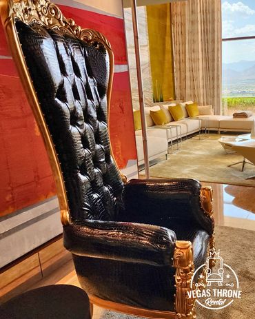 Black & gold throne chair styled in luxury suite for upscale events weddings and private gatherings