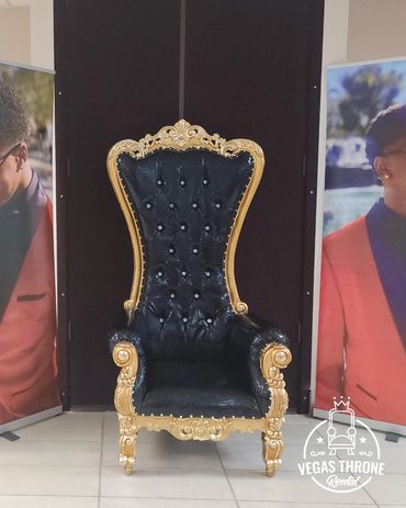 black &gold throne chair from Vegas Throne Rental set up at a photo booth for a stylish celebration