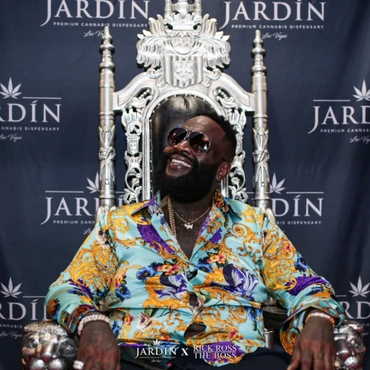 Silver lion throne with Rick Ross seated during a cannabis event promo at Jardin Las Vegas dispensary.
