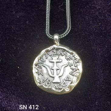 Hand-crafted pendant made from 925 Sterling Silver Widow's mite coin in A 14 14-karat gold frame.