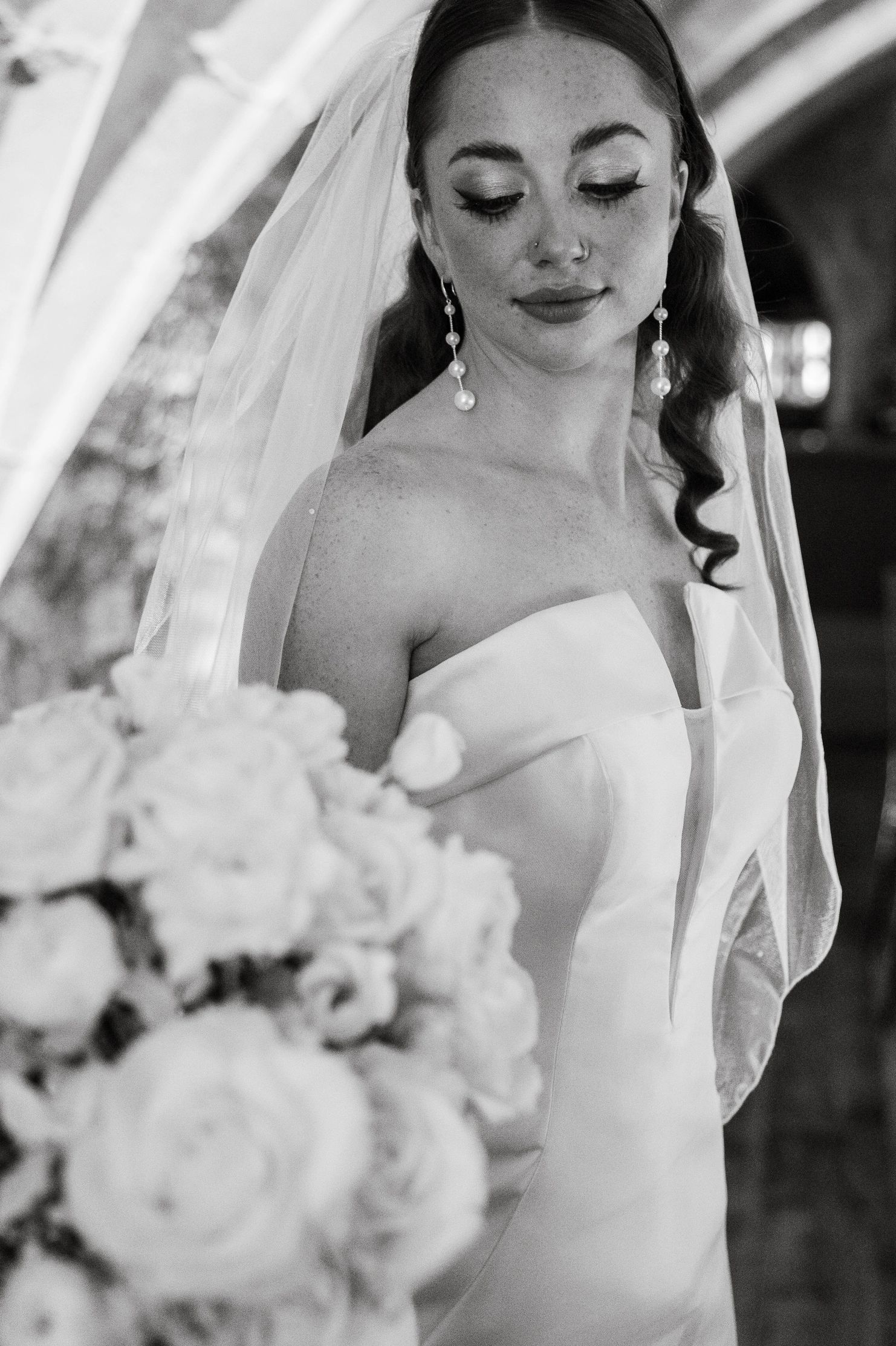 Our beautiful bride Hayley gazes at her luxury wedding bouquet