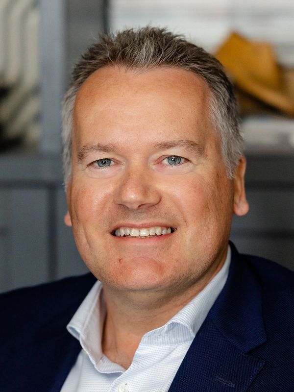 Smiling middle-aged man in business attire.