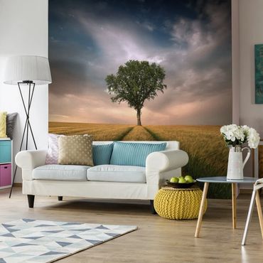 Modern living room with a nature-themed wall mural and cozy decor.