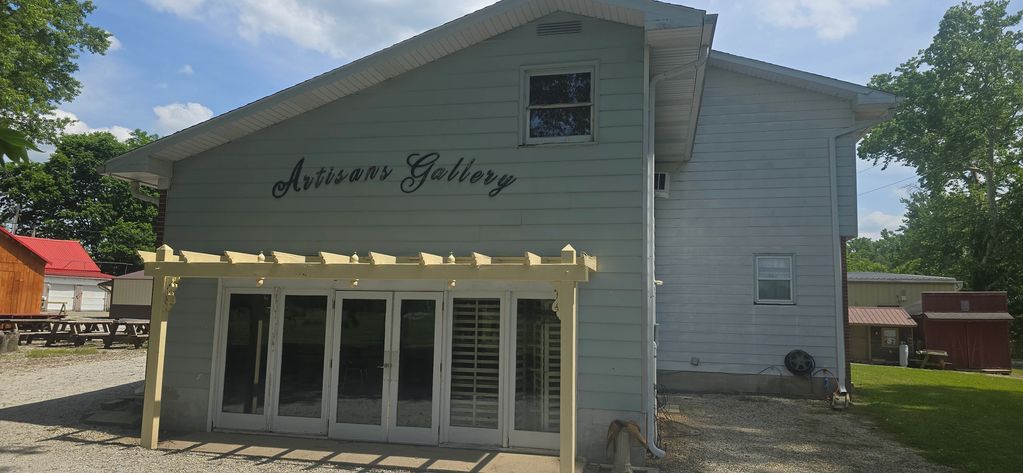 The exterior of Artisans Gallery with a pergola over the entrance.