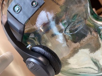 Black Galax headphones on a reflective surface.