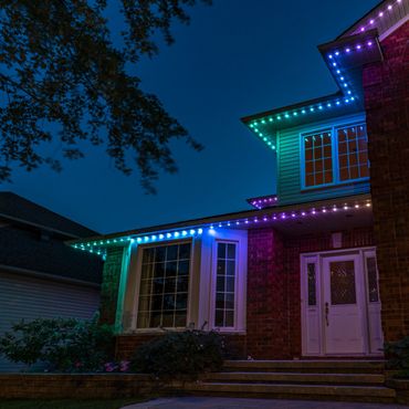 A house adorned with colorful LED lights during nighttime.