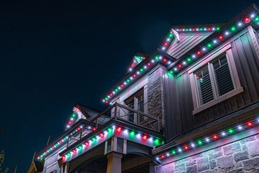 A house decorated with colorful Christmas lights at night.