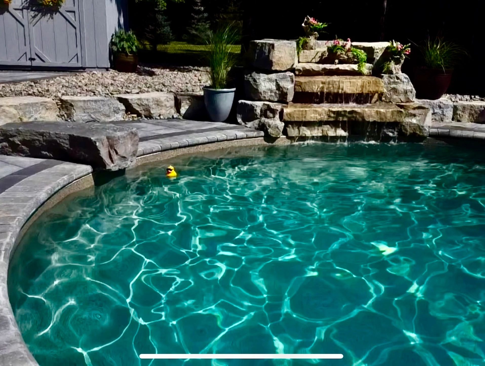 Inground pool with interlock pool deck in Simcoe County