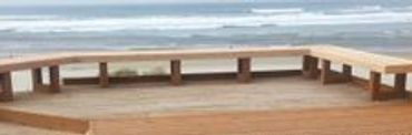 Construction of new cedar deck with bench overlooking the ocean.