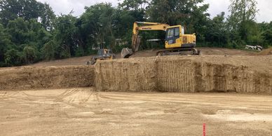 Excavator and skid steer digging foundation for new home. 