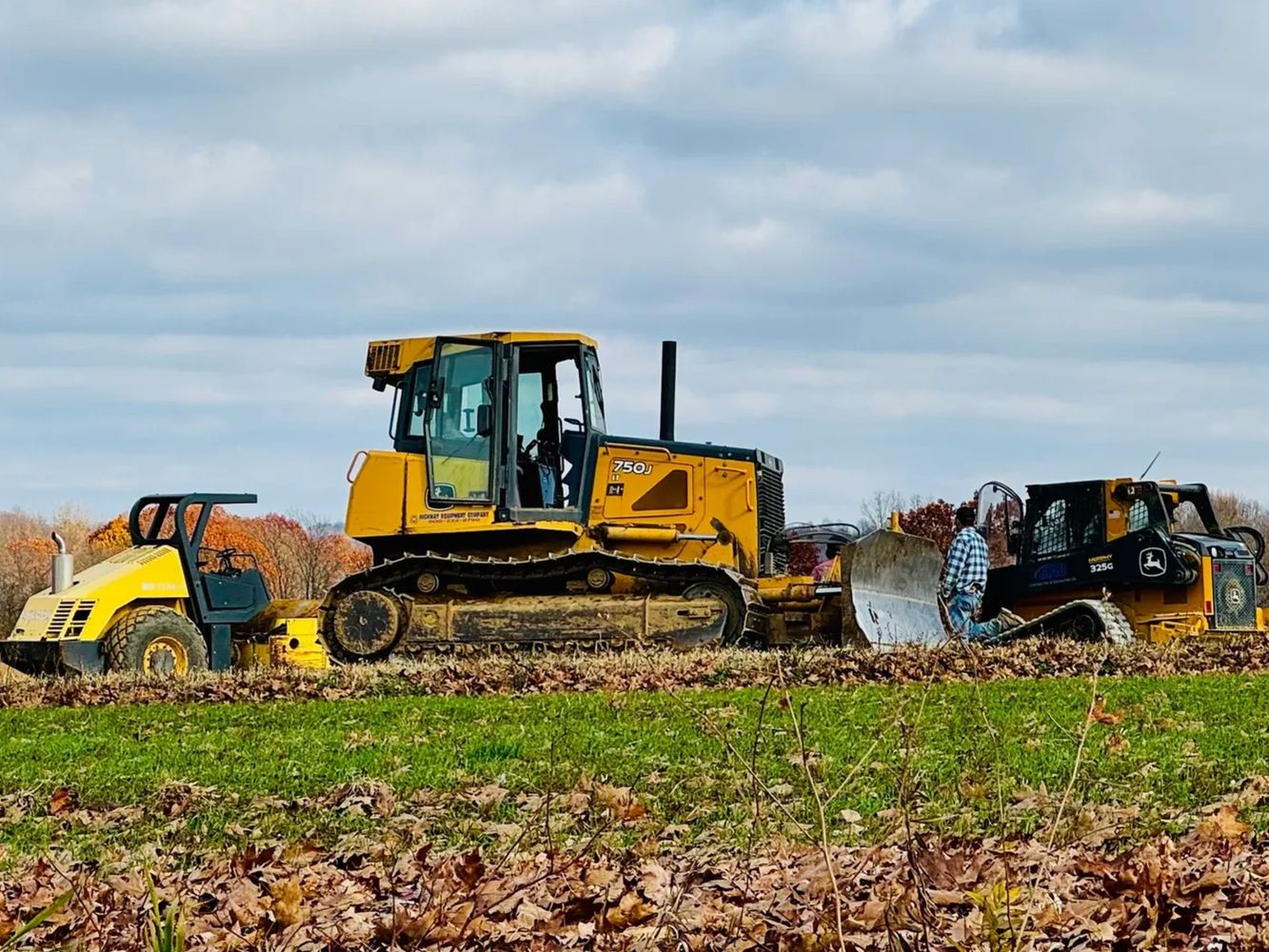 Roller, Bulldozer, Skid Steer excavating for building pad, foundation excavation.