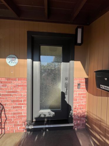 Exterior photo of a swing door installed in a home.