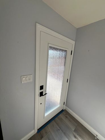 Interior photo of a swing door installed in a home.