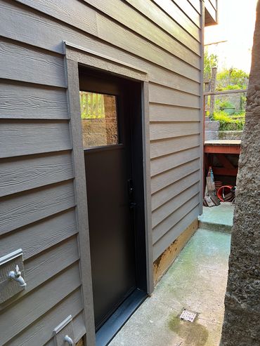 Exterior photo of a completed fiber cement installation by Supreme Contractors, Inc.