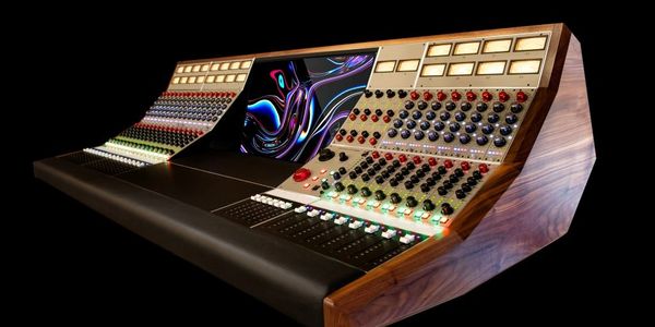A sleek, modern audio mixing console with numerous knobs, buttons