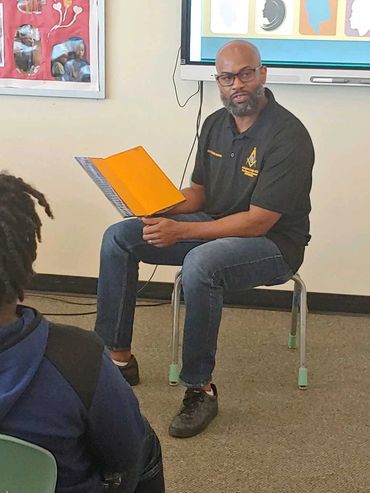 SW Charles Aaron reading to the kids at Kenmore Black History Day - 2/16/24