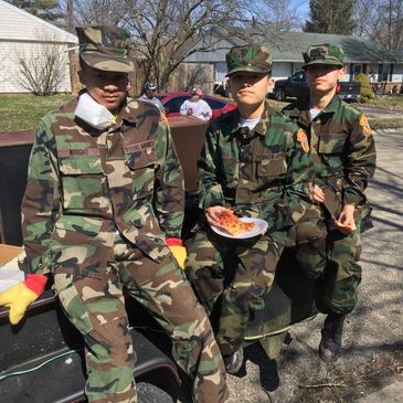 Young Marines resting after a hard day of cleaning up a veteran's home.