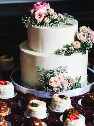 Two-tier vanilla cake, decorated with chantilly cream and natural flowers