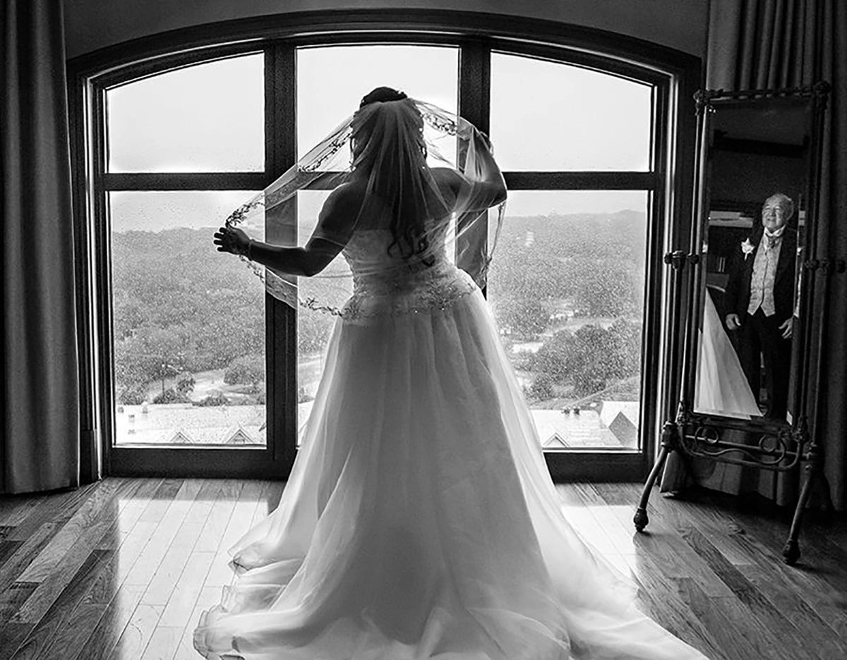 Dad in mirror seeing his daughter on her wedding day. Emerald Grande Destin, Fl