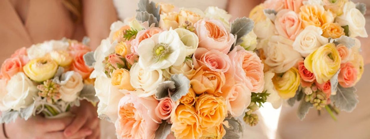 Three wedding bouquets in a row, featuring pastel pink, peach, and yellow flowers.