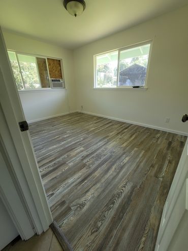 Donato Project; pink room now painted and new flooring put in with new base trim.