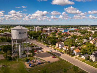 drone view overlooking east end brandon water tower, playground below, in residential neighbourhood