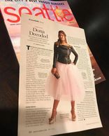 Picture of the Seattle magazine piece. Dona wearing a black leather jacket and a poofy pink skirt