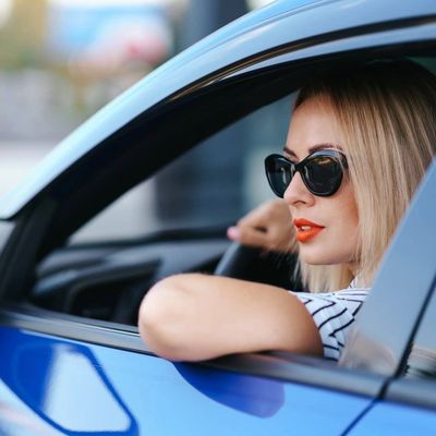 Woman driving blue car