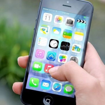 woman's hand holding an iPhone