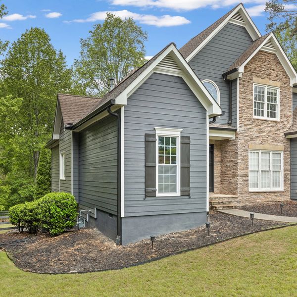 Blue and rock faced home in Milton, GA. Rocky Brook Construction.