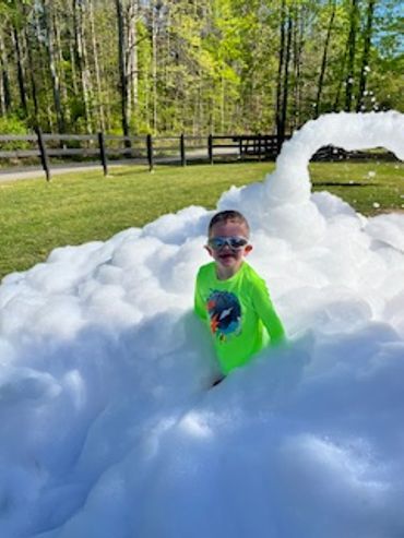 A Boy Playing With Heaps of Snow