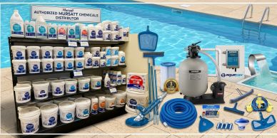 Various pool maintenance chemicals and equipment displayed by a pool.