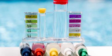 Water testing kit with color-coded tubes and pH indicator.