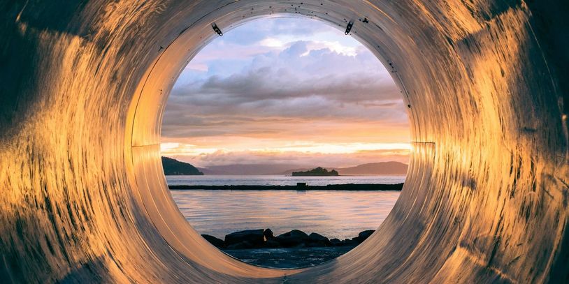 Sunset view through a circular tunnel.