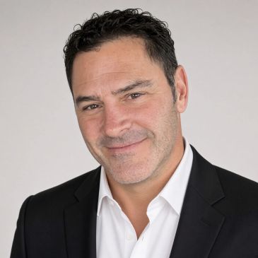 Smiling man in a suit jacket and white shirt