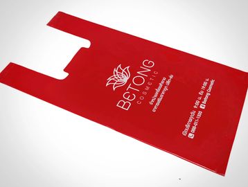Red promotional shopping bag from Betong Cosmetic.