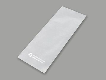 White paper napkin bag on gray background.
