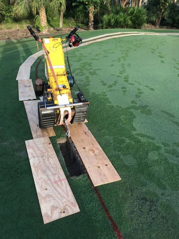 The barrier being installed to prevent rhizomes from encroaching.