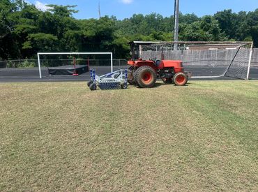Professional Turfgrass Services managing a soccer field using our Campey Unirake.