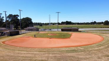 Professional Turfgrass Services managing a baseball field after laser grading and dirt work. ABI.