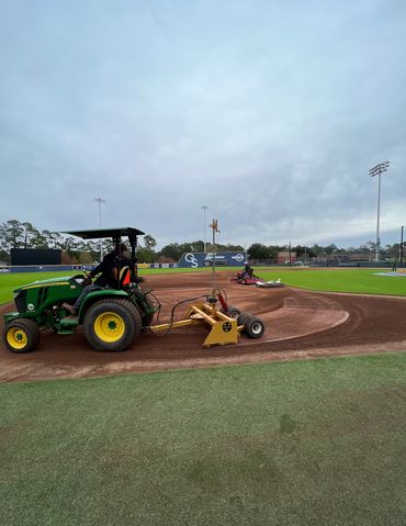 Professional Turfgrass Services laser grading baseball field.