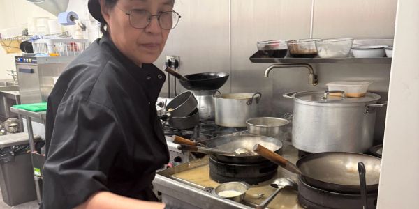 Aoy, our Chef cooking in our busy kitchen..