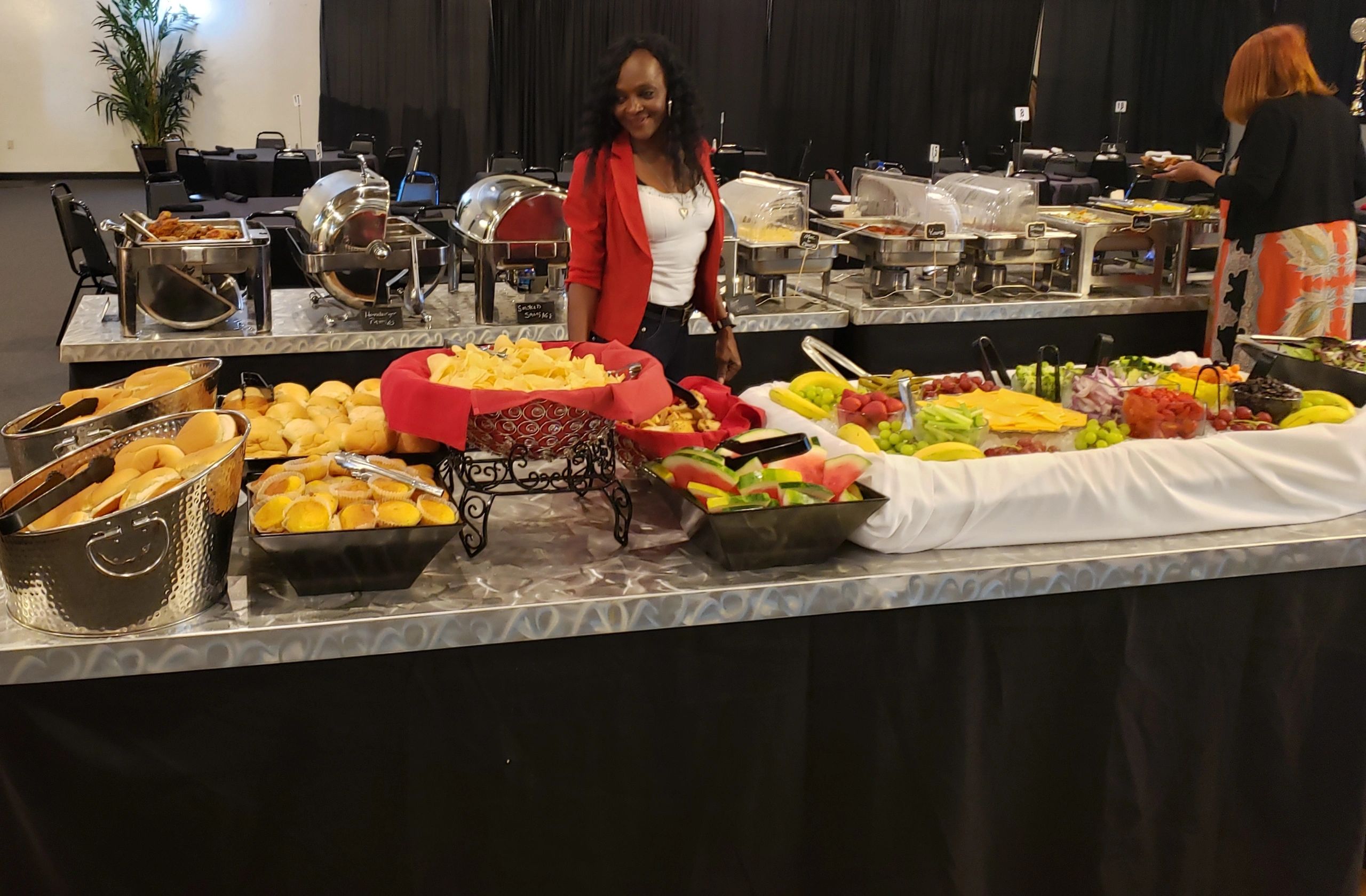 a woman looking at the available food in a catering
