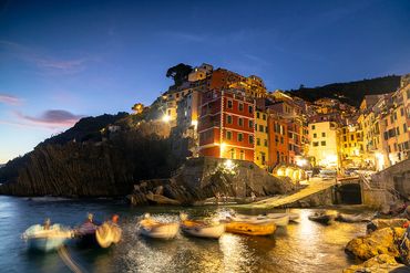 "Riomaggiore"
Night scene of village with small boats in the foreground.