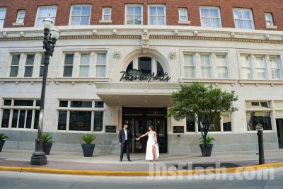 Couple holding hands outside Hotel Paso del Norte.