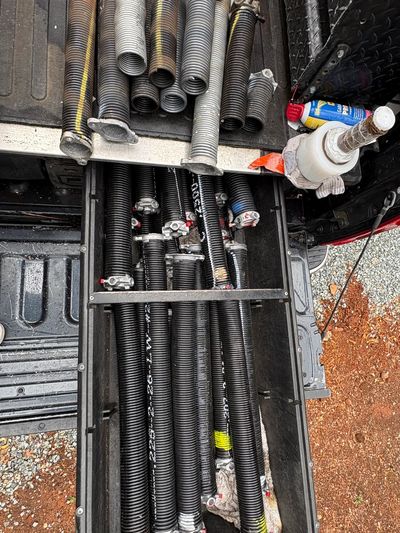 Broken garage door springs next to new inventory in Grass Valley, CA.